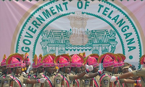 Officers from the newly formed Telangana state police march past the new state's coat-of-arms during Formation Day celebrations in Secunderabad, the twin city of Hyderabad on Monday. Celebrations erupted in southern India to mark the creation of the new state, the culmination of a campaign stretching back nearly six decades. The campaign to create a separate state in one of India's most economically deprived regions began in the late 1950s, with its champions arguing the region has been neglected by successive state governments. 