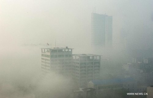 Buildings are seen amid dense fog in Wuhan City, capital of central China's Hubei Province, Jan. 12, 2013. (Xinhua/Cheng Min)&nbsp; 