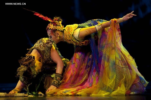 Dancers perform in the musical Hundred-bird Dress in Nanning, capital of south China's Guangxi Zhuang Autonomous Region, May 3, 2013. The musical tells a legend of the Zhuang ethnic group about a young hero's sacrifice in protecting the homeland against an evil polluting power. (Xinhua/Liu Jun) 