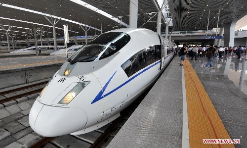 A bullet train traveling between Hangzhou and Nanjing parks at the Hangzhou East Raiway Station in Hangzhou, capital of east China's Zhejiang Province, July 1, 2013. The Nanjing-Hangzhou-Ningbo high-speed railway that stretches across east China's Yangtze River Delta began officially put into operation on July 1. The new high-speed railway is expected to boost the region's economy and foster the growth of tourism in the three cities it links (Xinhua/Wang Dingchang)