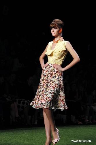 A model presents a creation by Austrian designer Lena Hoschek at the Spring/Summer 2014 Shows of the Mercedes-Benz Fashion Week, in Berlin, on July 2, 2013. (Xinhua/Pan Xu) 