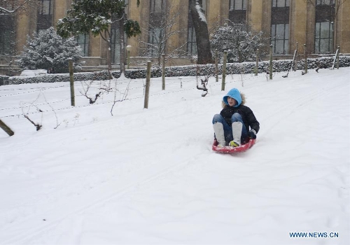 A teenager slides on snow-covered land in Paris, France, Jan. 20, 2013. French weather agency Meteo France has put 55 departments, including the Ile-de-France (Paris and its suburb), under orange alert and decided to maintain the alert system in these areas till Sunday afternoon based on lasting snowfalls in these areas where the snow is expected to be thick as up to 20 centimeters. (Xinhua/Li Genxing)