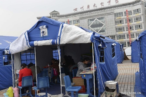 High school students study to prepare the college entrance exam this summer in a tent at a temporary settlement at the Tianquan Middle School in quake-hit Tianquan County, Ya'an City, southwest China's Sichuan Province, April 22, 2013. A 7.0-magnitude earthquake jolted Lushan County of Ya'an City in the morning on April 20. (Xinhua/Wang Jianhua)