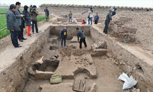Archeological workers work at at a newly discovered ancient workshop site in Zibo, east China's Shandong Province, April 23, 2013. A bronze mirror workshop, dating from some 2,000 years ago in China's Han Dynasty (202 B.C.-220 A.D.), was discovered in Zibo and believed to be the first of its kind discovered in China. Photo: Xinhua