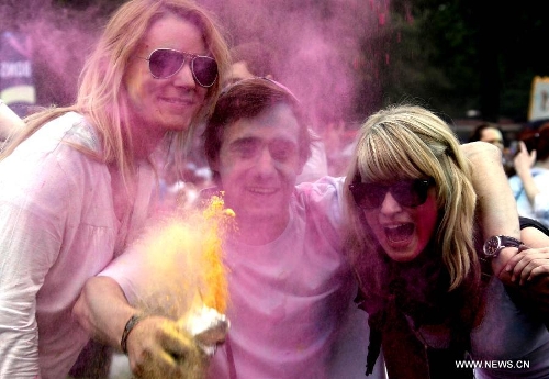 People throw colorful powder during the Holi Festival of Colours, at the Reiterstadion in Berlin, Germany, May 11, 2013. The celebration of Holi Festival of Colours has been launched in Germany since 2012 as a new carnival of German people marking the advent of spring. (Xinhua/Pan Xu) 