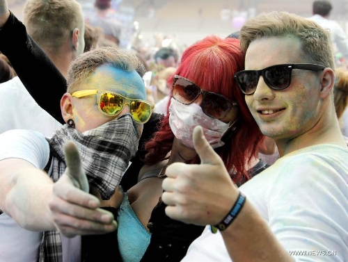 People have their faces covered with colorful powder during the Holi Festival of Colours, at the Reiterstadion in Berlin, Germany, May 11, 2013. The celebration of Holi Festival of Colours has been launched in Germany since 2012 as a new carnival of German people marking the advent of spring. (Xinhua/Pan Xu) 