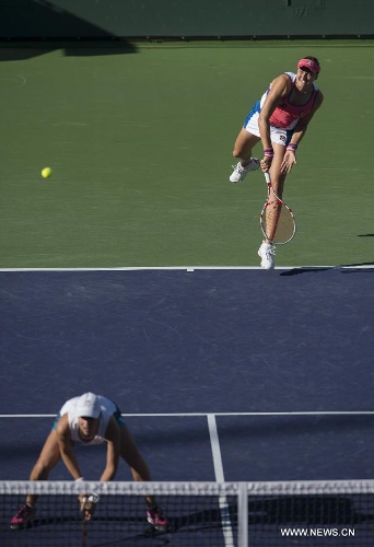 Nadia Petrova (top) of Russia and Katarina Srebotnik of Slovenia play during the women's doubles semifinal match against Hsieh Su-Wei of Chinese Taipei and Peng Shuai of China in the BNP Paribas Open in Indian Wells, California, March 14, 2014. Petrova and Srebotnik won 2-0 to enter the final. (Xinhua/Yang Lei)