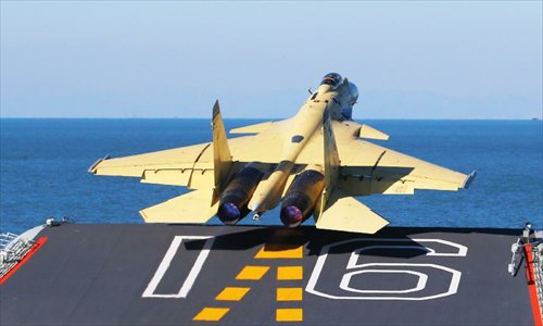 This undated photo shows a carrier-borne J-15 fighter jet taking off from China's first aircraft carrier, the Liaoning. China has successfully conducted flight landing on its first aircraft carrier, the Liaoning. After its delivery to the People's Liberation Army (PLA) Navy on Sept. 25, the aircraft carrier has undergone a series of sailing and technological tests, including the flight of the carrier-borne J-15. Capabilities of the carrier platform and the J-15 have been tested, meeting all requirements and achieving good compatibility, the PLA Navy said. Designed by and made in China, the J-15 is able to carry multi-type anti-ship, air-to-air and air-to-ground missiles, as well as precision-guided bombs. The J-15 has comprehensive capabilities comparable to those of the Russian Su-33 jet and the U.S. F-18, military experts estimated. Photo: Xinhua