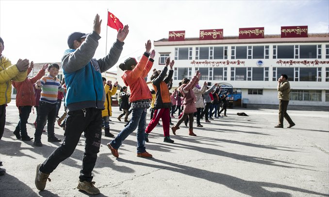 Students do morning exercises at a primary school in Aba on March 4.