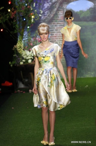 Models present creations by Austrian designer Lena Hoschek at the Spring/Summer 2014 Shows of the Mercedes-Benz Fashion Week, in Berlin, on July 2, 2013. (Xinhua/Pan Xu) 