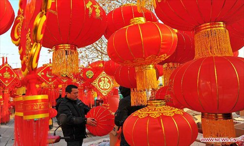 People select red lanterns for the coming Spring Festival in Qingzhou City, east China's Shandong Province, Feb. 8, 2013. The Spring Festival, the most important occasion for the family reunion for the Chinese people, falls on the first day of the first month of the traditional Chinese lunar calendar, or Feb. 10 this year. Photo: Xinhua