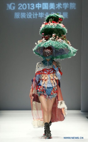 A model presents a creation designed by students from China Academy of Art during the 1st China Graduate Fashion Week in Beijing, capital of China, April 24, 2013. A total of 610 graduate students from 22 universities will present their designs during the five-day event which kicked off on Wednesday. (Xinhua/Chen Jianli)