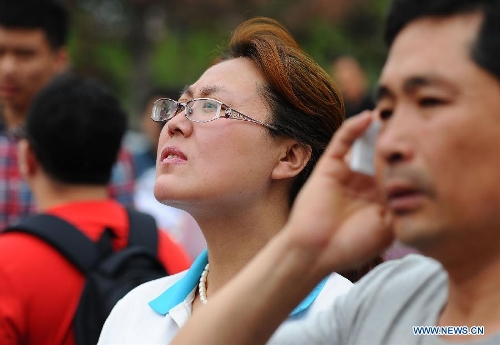 A mother watches her child entering the exam room to take the national college entrance exam at the No. 11 High School in Changchun, capital of northeast China's Jilin Province, June 7, 2013. Some 9.12 million applicants are expected to sit this year's college entrance exam on June 7 and 8. (Xinhua/Xu Chang)