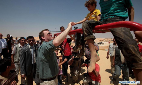 Canadian Foreign Minister John Baird (C) visits the Zaatari camp for Syrian refugees, 15 kilometres (nine miles) from the kingdom's northern city of Mafraq, near the border with Syria, on August 11, 2012. There are now about 3,000 Syrians taking shelters in the desert Zaatari refugee camp that was opened last month to alleviate the humanitarian crisis. Photo: Xinhua