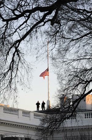 Security personnel are seen beside a U.S. flag flying at half staff to honor the victims of the Connecticut shooting incident at the White House in Washington D.C., capital of the United States, Dec. 14, 2012. US President Barack Obama on Friday ordered US flags to be flown at half-staff at the White House and all public buildings and grounds, as a mark of respect for the victims of a deadly shooting spree at Sandy Hook Elementary School in Newtown, Connecticut, which took place earlier in the day. Photo: Xinhua