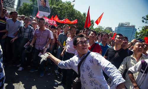 Chinese people rallies in front of Japan embassy in Beijing on Saturday to protest Japan's so-called 