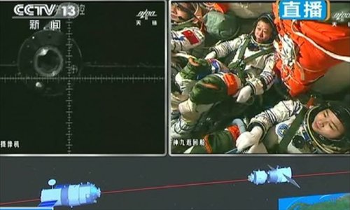 TV grab taken on June 24, 2012 shows manual docking between Shenzhou-9 spacecraft and Tiangong-1 lab module being conducted. A manual docking between Shenzhou-9 spacecraft and the orbiting Tiangong-1 lab module has been successful Sunday. It means China has completely grasped the space rendezvous and docking technologies and had the fundamental abilities to build a space station.Photo: Xinhua