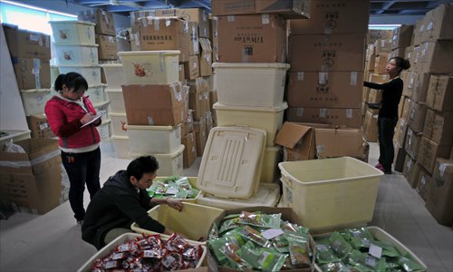 Staff of a Taobao store in Hangzhou package ordered products at their storage base. Photo: CFP