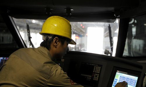 Technician Huang Junhao checks a train driver's cabin. Photo: Yang Hui/GT