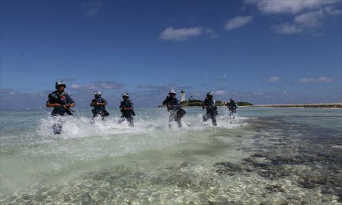 Soldiers race through shallow water towards the finish line during a PLA military training competition held on the Xisha Islands, South China Sea on December 5. Photo: mil.cnr.cn