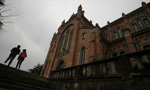 Visitors walk in front of the Sheshan church which is under renovation on March 13 in Shanghai. Photo: IC