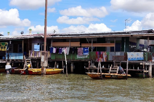 Photo taken on April 24, 2013 shows a house in the Water Village in Brunei's capital city Bandar Seri Begawan. Dubbed as Venice of the East and situated along the Brunei River, Kampong Ayer is the world's largest water village, sheltering about 30,000 inhabitants. It covers an area of 2.6 square kilo-meters and consists of 10 villages whose building are constructed on the Brunei River. (Xinhua/Li Peng) 