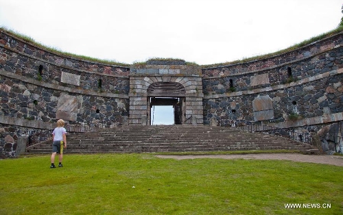 A tourist visits the monumental King's Gate of the island fortress of Suomenlinna in Helsinki, capital of Finland, on June 24, 2013. Fortress of Suomenlinna is a unique historical monument and one of the largest maritime fortresses in the world. Its construction began in 1700s when Finland was part of the Kingdom of Sweden. As an example of European military architecture of its time, Suomenlinna was included in UNESCO's World Heritage List in 1991. (Xinhua/Yan Ting) 