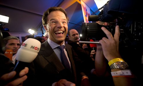 Netherlands' Prime Minister and conservative-liberal party VVD leader Mark Rutte smiles in front of the media at the Carlton Beach Hotel in Scheveningen, The Hague on Wednesday, where he gathered with his party to await the country's general election results. Photo: AFP 