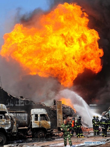 Firefighters put out the fire at the accident site after an explosion ripped through a warehouse of a chemical factory in the Dongxihu District of Wuhan, capital city of central China's Hubei Province, April 13, 2013. The casualties were unknown so far. (Xinhua/Xiao Yijiu) 