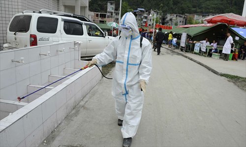 A staff member from the local disaster prevention and control center disinfects the Lingguan Middle School in Lingguan county, Sichuan Province on April 24. Photo: Li Hao/GT