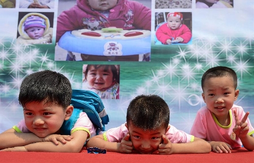 Young boys pose at a birthday party at the Luohan Temple in Shifang City, southwest China's Sichuan Province, May 12, 2013. The children were born at the Luohan Temple five years ago after the devastating earthquake jolted Wenchuan County of Sichuan on May 12, 2008. The temple then was used as a temporary obstetrics hospital from May 13 to Aug. 7 in 2008 to deliver newborn babies. A total of 108 babies were born at the temple until the local maternal and child health care hospital reopened. (Xinhua/Jiang Hongjing) 