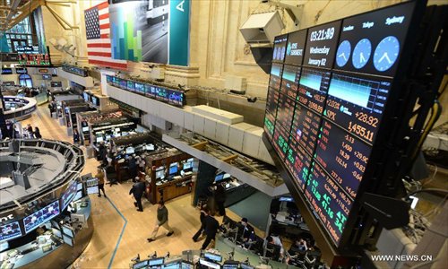 Traders work on the floor of the New York Stock Exchange, New York, the United States, on January 2, 2013.