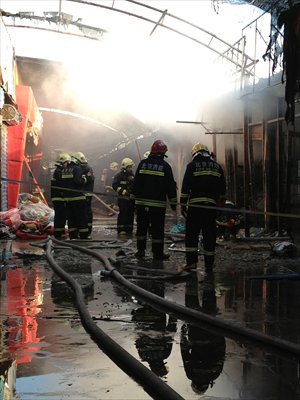 Firefighters extinguish a fire at a dog market on Wednesday in Liyuan, Tongzhou district. No casualties were reported. Photo: CFP