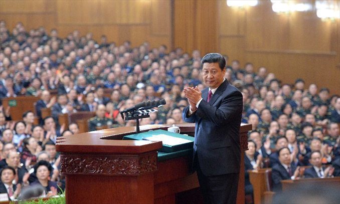Newly-elected Chinese President Xi Jinping applauds while saluting his predecessor Hu Jintao during the closing meeting of the first session of the 12th National People's Congress (NPC) at the Great Hall of the People in Beijing, capital of China, March 17, 2013. Photo: Xinhua