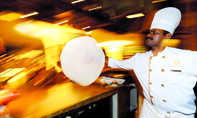 Pandi, 35, prepares a roti prata at a restaurant in Hefei, capital of Anhui Province. From India, Pandi came to work as a chef in China two years ago. Photo: CFP