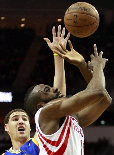 James Harden (R) of Houston Rockets competes during the NBA game against Golden State Warriors in Houston, the United States, on March 17, 2013. (Xinhua/Song Qiong) (lm) 