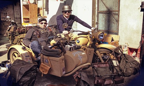 Two customers sit in a vintage motorcycle and sidecar at the Dreams Flea Market. 