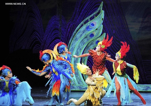 Dancers perform in the rehearsal of the musical Hundred-bird Dress in Nanning, capital of south China's Guangxi Zhuang Autonomous Region, April 27, 2013. The musical tells a legend of the Zhuang ethnic group about a young hero's sacrifice in protecting the homeland against an evil polluting power. (Xinhua/Liu Jun) 