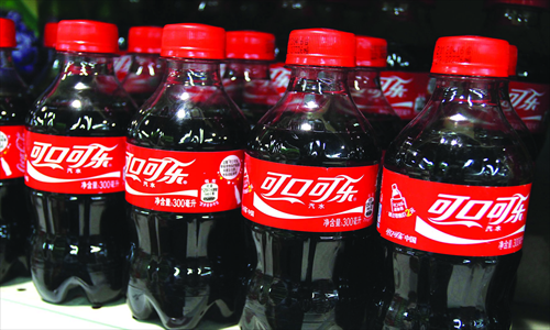 Bottles of Coca-Cola are seen in a supermarket in Xuchang, Central China's Henan Province on May 26, 2013. Photo: CFP