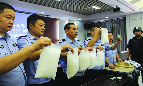 Police officers display drugs confiscated in a crackdown at a press conference held in Xi'an, Shaanxi Province, on August 25. Photo: CFP