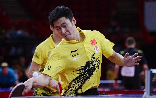Wang Liqin (front) and Rao Jingwen of China compete during the first round of mixed doubles against Thavisack Phathaphone and Thiphakone Southammavong of Laos at Palais omnisport de Paris Bercy in Paris, France, on May 14, 2013. Wang and Rao won 4-0. (Xinhua/Tao Xiyi) 