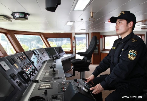 A staff member operates patrol vessel Haixun01 for a test in Shanghai, east China, April 15, 2013. Haixun 01, soon to be put into service and managed by the Shanghai Maritime Bureau, is China's largest and most advanced patrol vessel. The 5,418-tonnage Haixun01 is 128.6 meters in length and has a maximum sailing distance of 10,000 nautical miles (18,520 km) without refueling. It will carry out missions regarding maritime inspection, safety monitoring, rescue and oil spill detection and handling. (Xinhua/Chen Fei) 