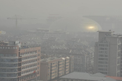 Sand and dust blanket buildings in Beijing, capital of China, March 9, 2013. A cold front brings strong wind as well as sand and dust to Beijing on March 9. (Xinhua/Lu Peng)