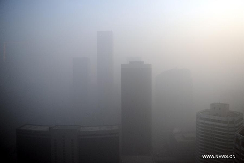  Buildings are shrouded in a dense smog near the CBD (Central Business District) area in Beijing, capital of China, Jan. 12, 2013. Beijing was shrouded in dense smog for a second straight day Saturday. The smoggy weather will not clear up until Monday, the city's environment monitoring center said. Beijing's air is heavily polluted. Readings for PM2.5, or airborne particles with a diameter of 2.5 microns or less -- small enough to deeply penetrate the lungs -- were as high as 456 on Saturday. (Xinhua/Luo Xiaoguang)