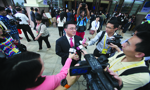 Zhang Yaqin, global vice president of Microsoft Corporation, is interviewed by a crowd of reporters at the Boao Forum for Asia Sunday. Photo: CFP