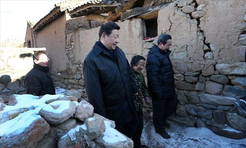 Xi Jinping (L, front), general secretary of the Communist Party of China (CPC) Central Committee and chairman of the CPC Central Military Commission, visits the family of Tang Zongxiu (C, front), an impoverished villager in the Luotuowan Village of Longquanguan Township, Fuping County, north China's Hebei Province, Dec. 30, 2012. Xi made a tour to impoverished villages in Fuping County from Dec. 29 to 30, 2012.  Photo: Xinhua