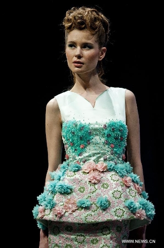 A model presents a creation of Indonesian brand Jeanny Ang Couture's 2013 spring/summer series at the 11th 