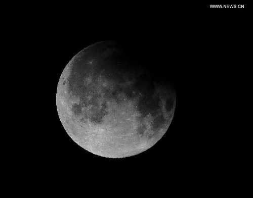 Photo taken on April 26, 2013 shows a partial lunar eclipse over the sky of Beijing, capital of China. The earth casts a shadow on the face of the moon and makes the partial lunar eclipse. (Xinhua/Li Xin)&nbsp; 