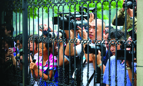 Reporters crowd to cover a gang rape trial involving a teenage son of two renowned Chinese singers outside the Haidian District People's Court in Beijing on August 28. Photo: CFP 