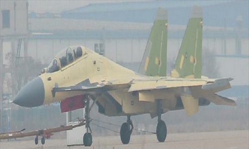 A two-seat variant of the J-15 carrier-based fighter is spotted Saturday at the runway of the Shenyang Aircraft Corporation (SAC), Liaoning Province, two days after the maiden flight of SAC’s stealth fighter dubbed as “J-31.”